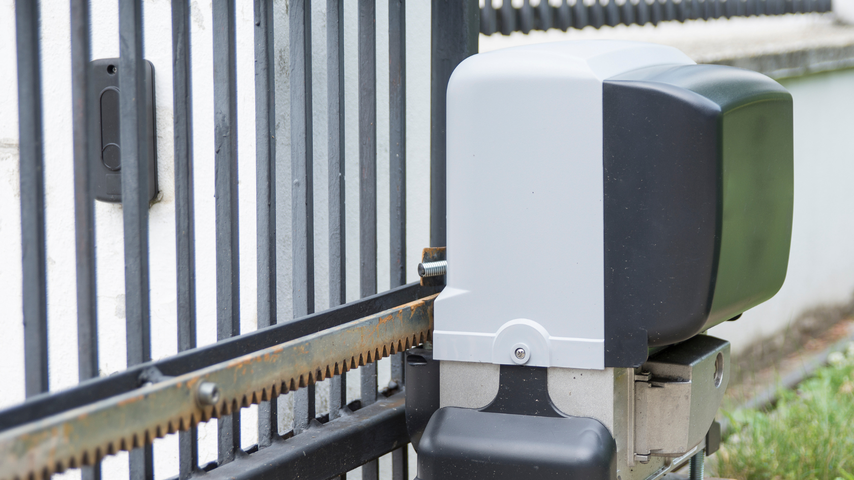 A close up of a metal gate with a device attached to it