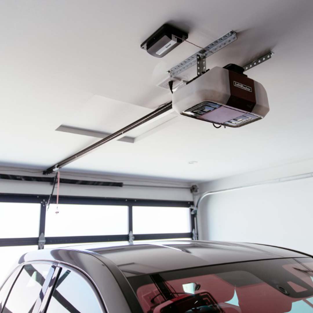 A car parked in a garage with a camera attached to the ceiling