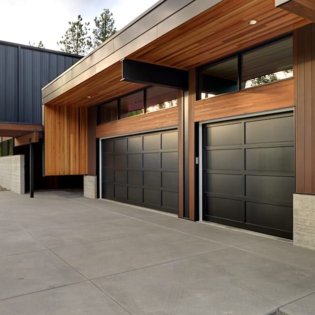 A large garage with two garage doors on the side of it