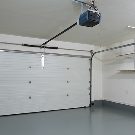 A garage with a garage lift in the middle of it