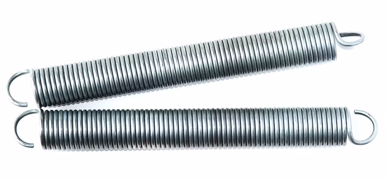 Garage door extension springs running along the side tracks.