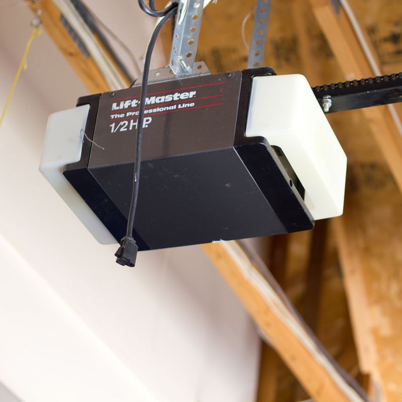 A black and white device hanging from a ceiling