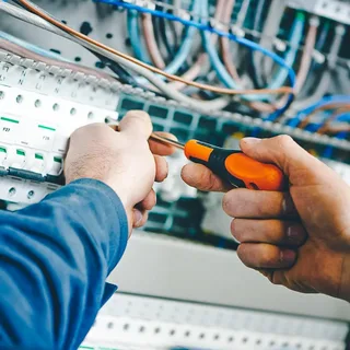 A man is working on a switch box