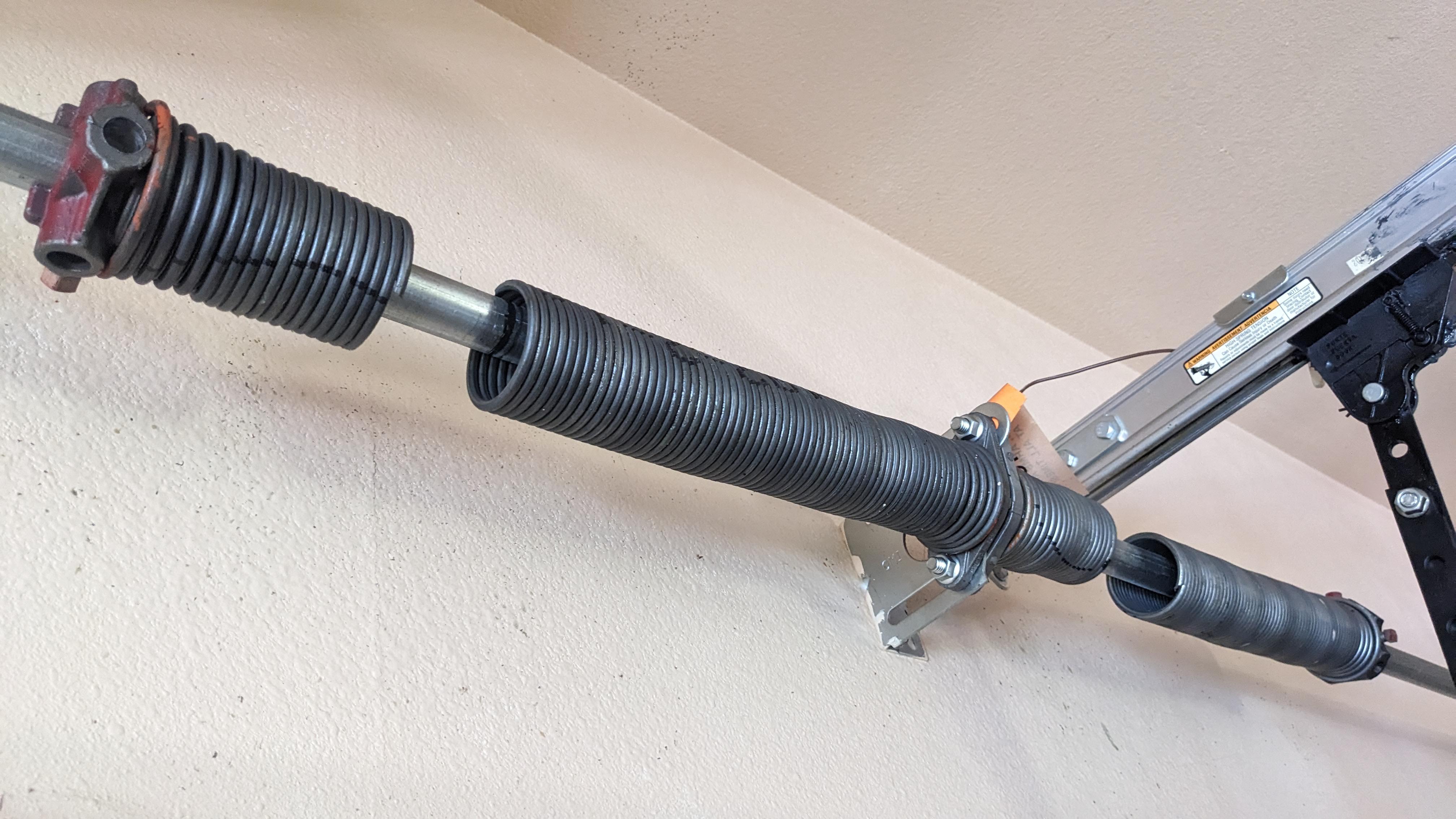 Close-up of a garage door torsion spring system.