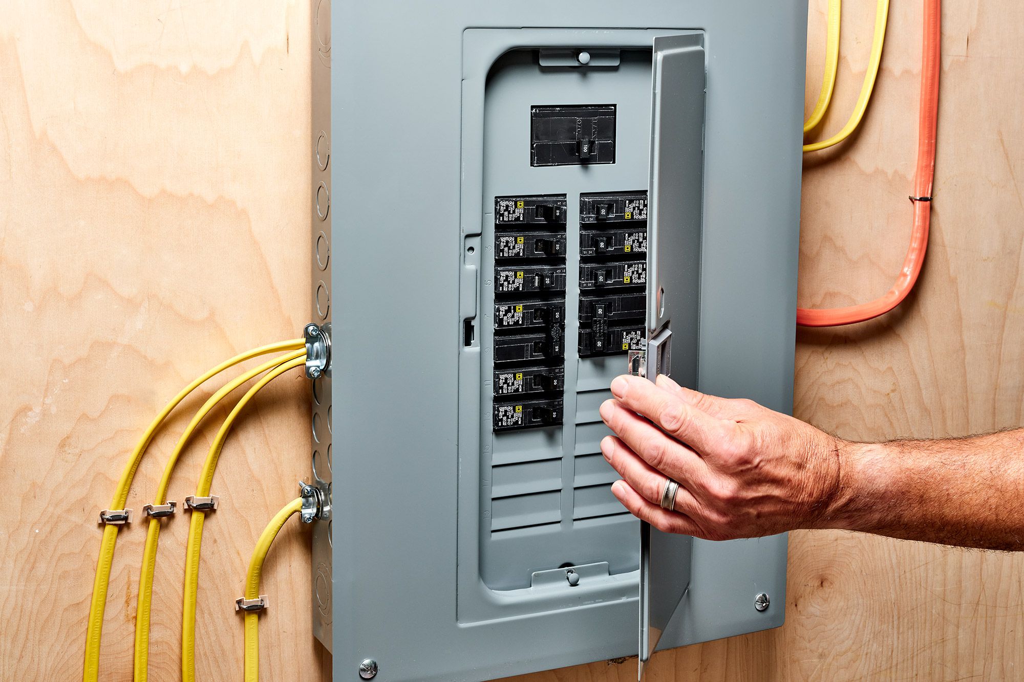 A man is working on an electrical panel