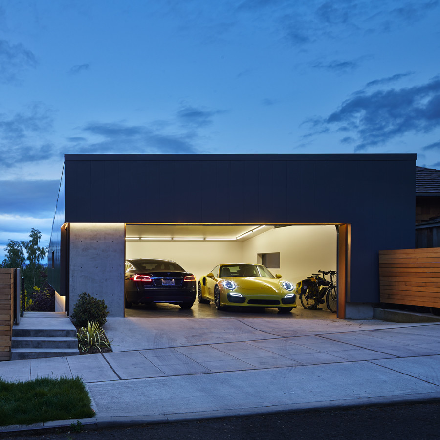 A couple of cars parked in a garage